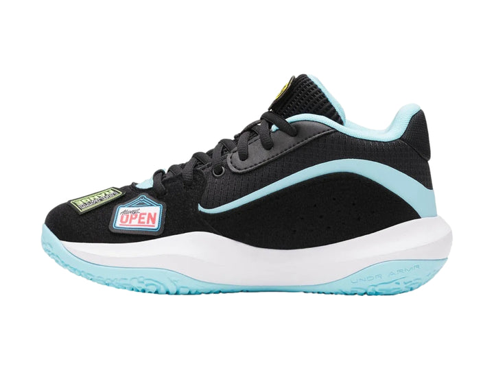 Tenis de baloncesto Under Armour color negro con detalles en celeste y blanco, decorados con parches coloridos.