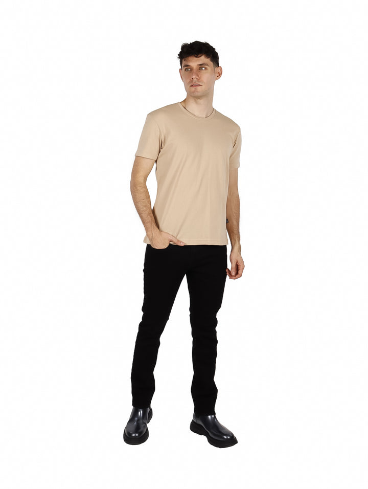 Hombre vistiendo una playera básica de color beige con cuello redondo y manga corta.