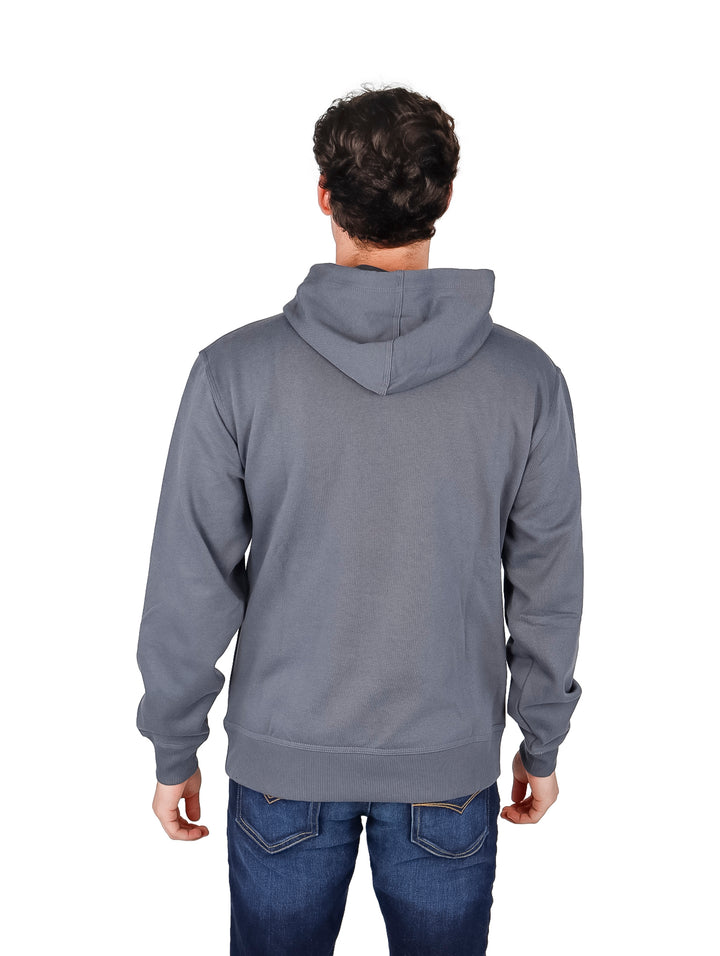 Hombre vistiendo una sudadera con capucha color gris oscuro de la marca Champion con logotipo en el pecho.
