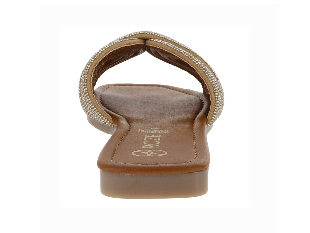Sandalia plana color oro para niña con tira frontal trenzada y detalles brillantes.