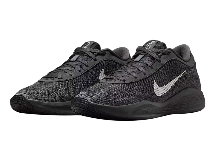 Tenis de baloncesto Nike GT Hustle Academy en color gris oscuro y negro con el logotipo de Nike en blanco.