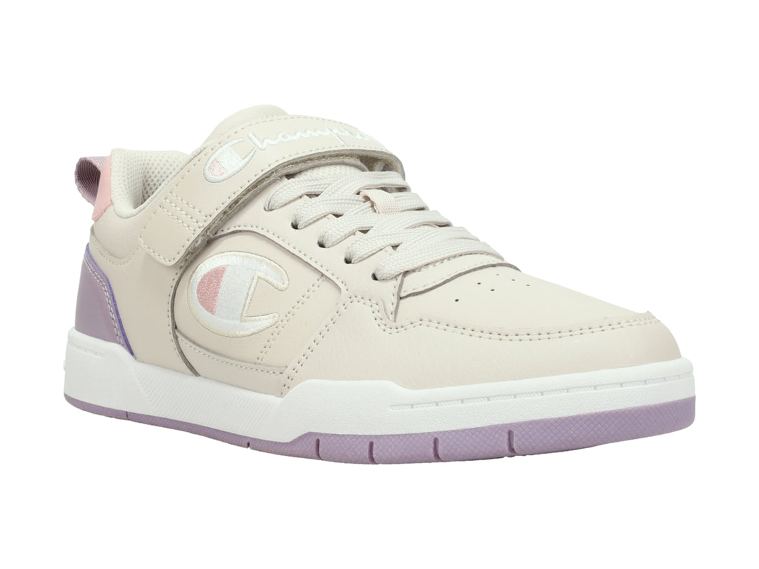 Tenis Champion color beige y morado con correa ajustable y suela blanca.