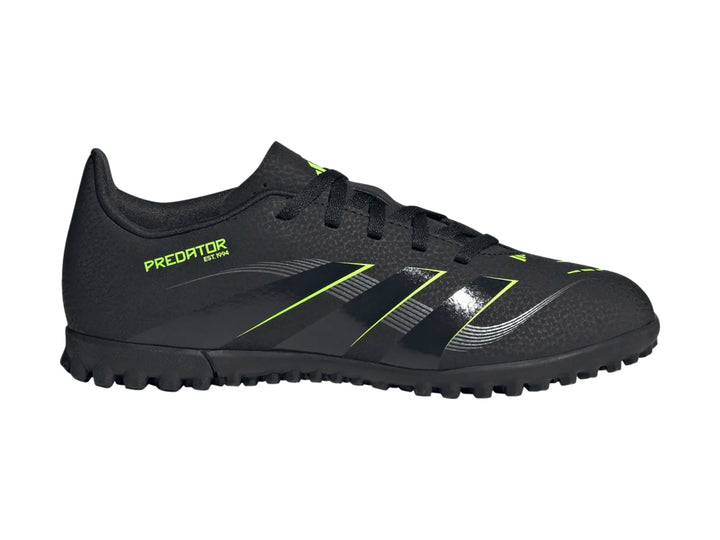 Zapato de fútbol Adidas Predator color negro con detalles en verde lima y suela para césped sintético.