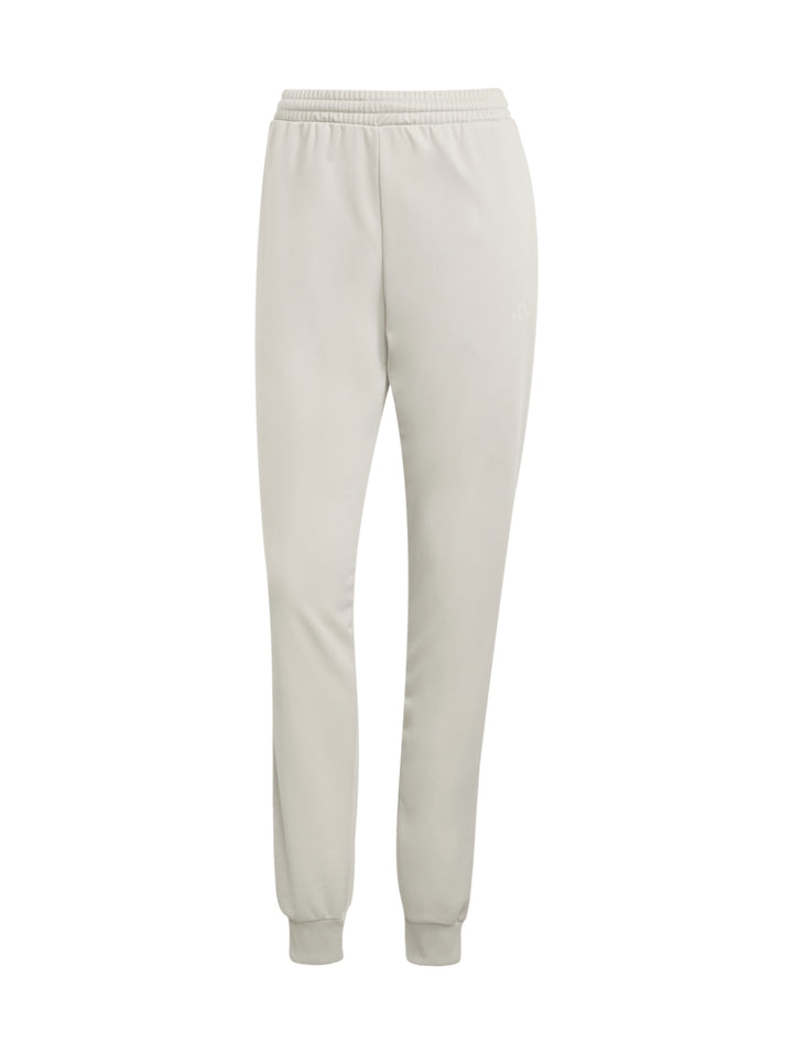 Conjunto deportivo Adidas Essentials Feel Cozy en color beige, compuesto por chaqueta y pantalón para mujer.