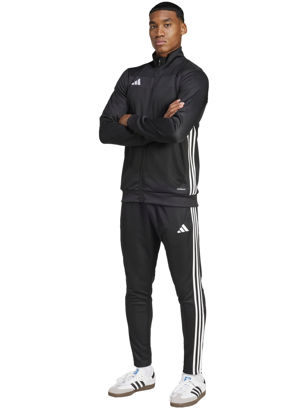 Hombre vistiendo conjunto deportivo Adidas Tiro 25 color negro con franjas blancas laterales.