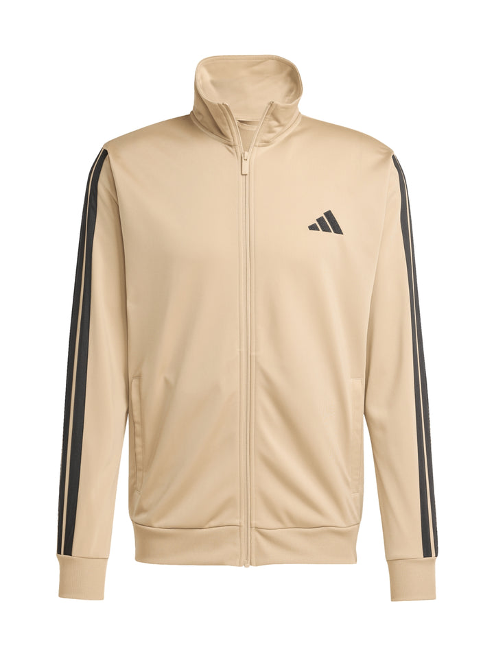 Conjunto deportivo Adidas color arena con tres franjas negras laterales, incluye chamarra y pantalón.