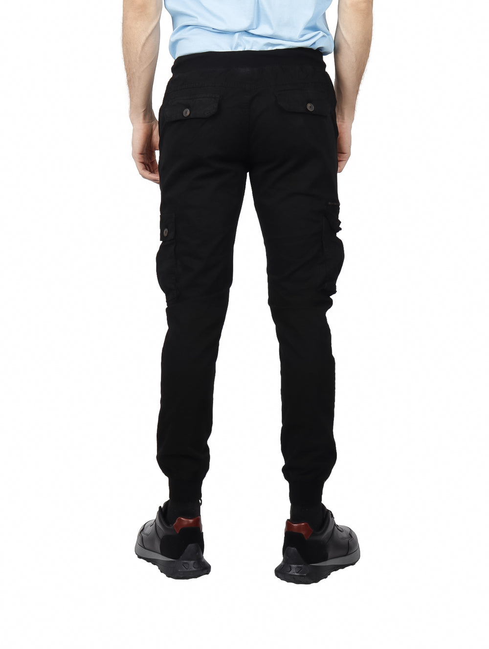 Hombre vistiendo pantalones jogger cargo color negro con bolsillos laterales y puños elásticos.