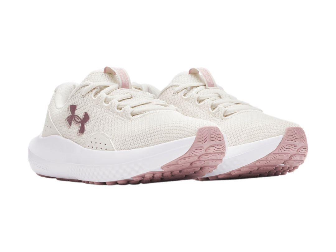 Tenis deportivos Under Armour blancos con detalles en rosa y malla transpirable.