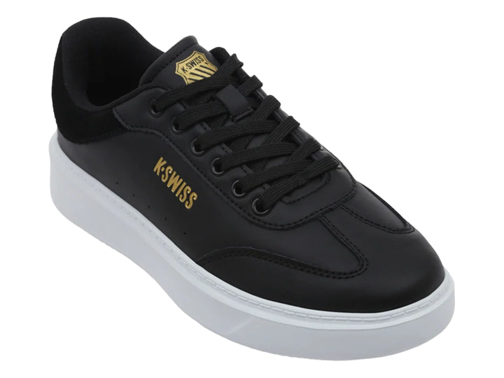 Tenis K-Swiss modelo Aldina en color negro con suela de plataforma blanca y logotipo dorado lateral.