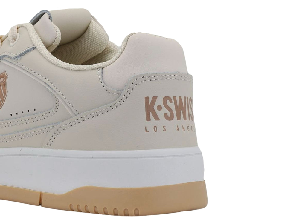 Tenis K-Swiss color taupe con suela blanca y base de goma color miel.