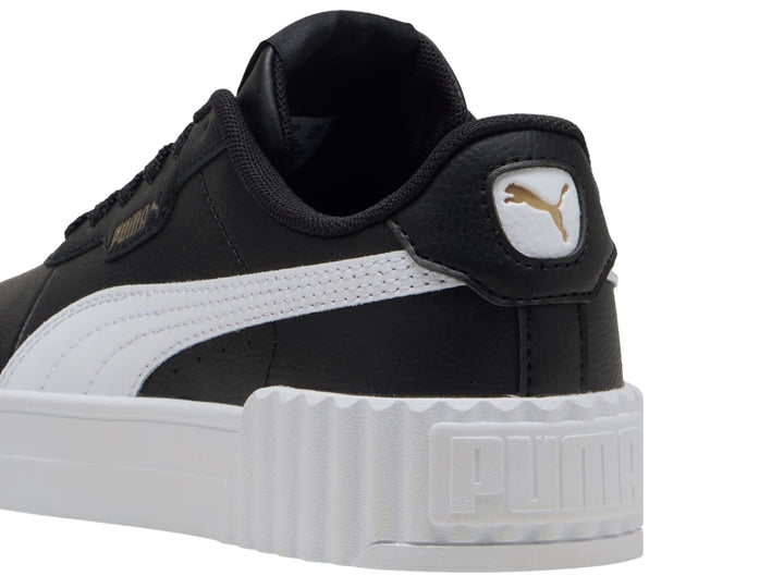 Tenis PUMA Carina 3.0 JR color negro con suela blanca de plataforma y detalles dorados.
