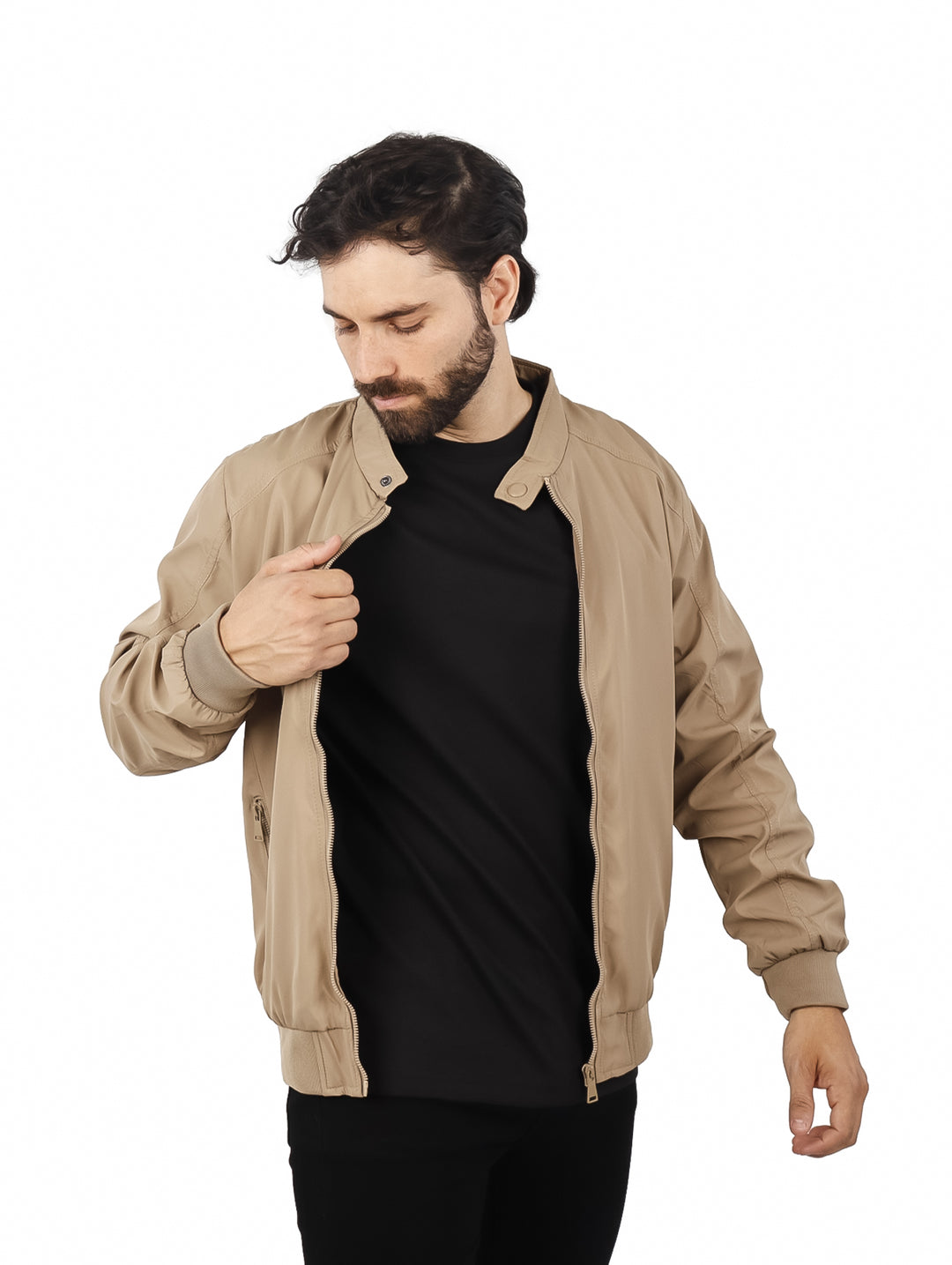 Hombre usando una chamarra tipo bomber de color beige con camiseta negra.