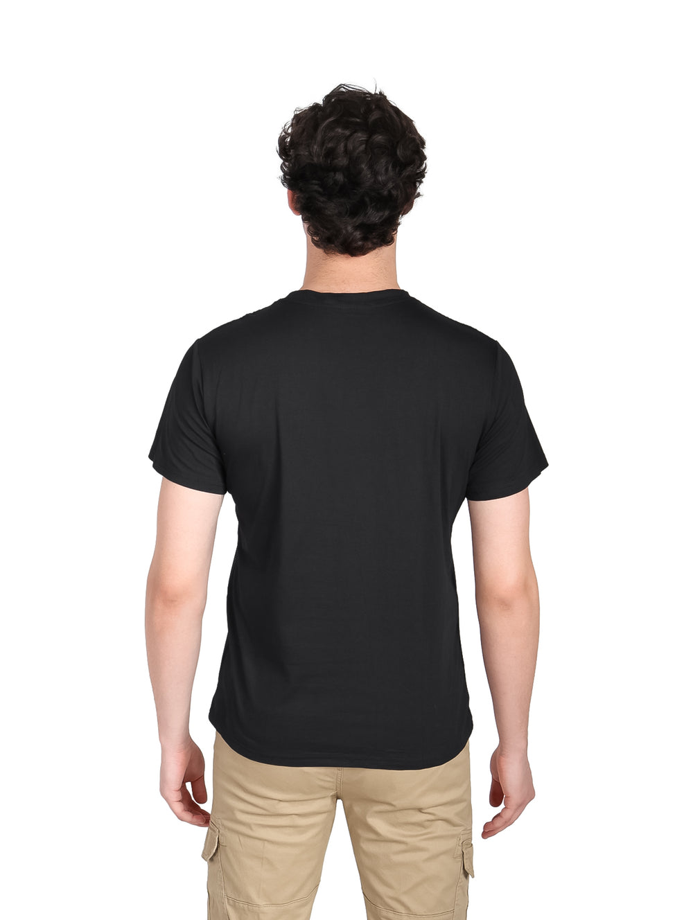 Hombre vistiendo una playera negra de manga corta con estampado frontal y pantalones color beige.
