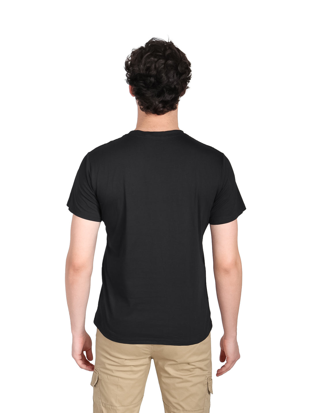 Hombre vistiendo una playera negra de manga corta con estampado frontal y pantalones color beige.