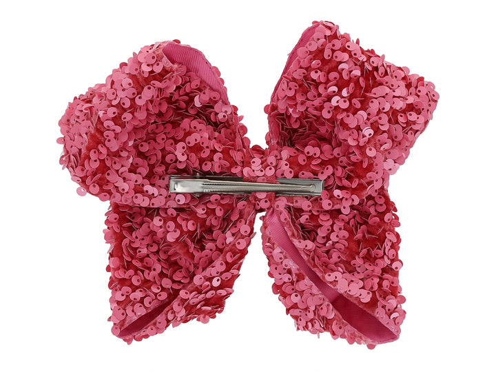 Moño para el cabello de color rosa palo cubierto de lentejuelas brillantes.