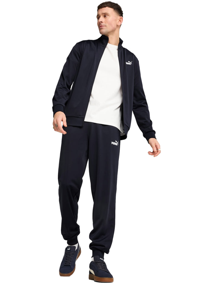 Conjunto deportivo PUMA color azul marino compuesto por chaqueta con cierre y pantalón largo.