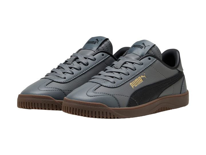 Tenis PUMA infantiles color gris oscuro con franja negra y suela color café.