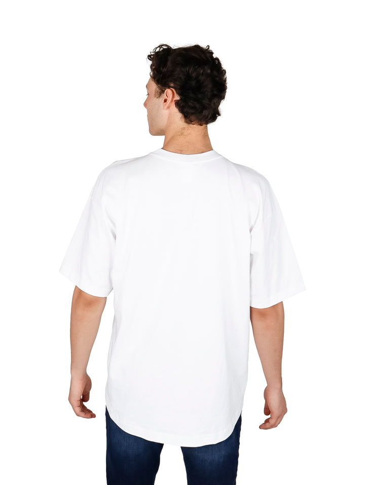 Hombre vistiendo playera blanca oversize de manga corta y cuello redondo.