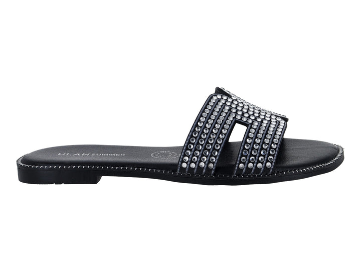 Sandalias planas color negro para mujer con tiras decoradas con brillantes.
