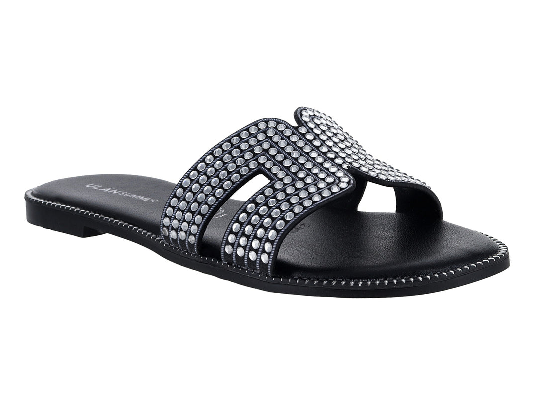 Sandalias planas color negro para mujer con tiras decoradas con brillantes.
