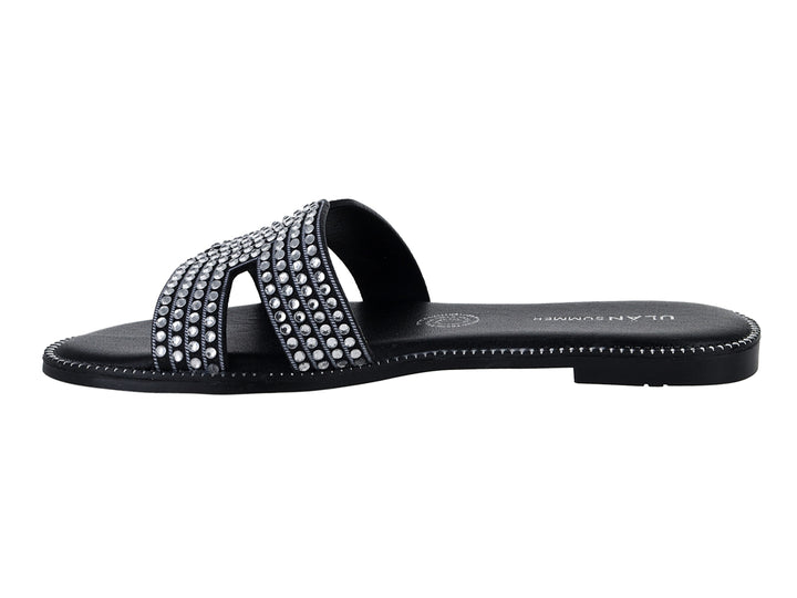 Sandalias planas color negro para mujer con tiras decoradas con brillantes.