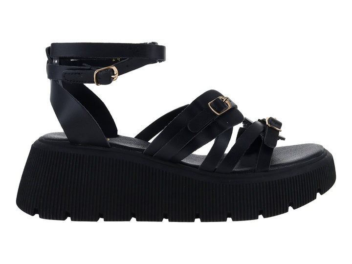 Sandalias negras de plataforma con suela track y correas ajustables con hebillas doradas.