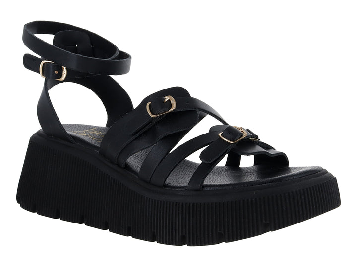 Sandalias negras de plataforma con suela track y correas ajustables con hebillas doradas.