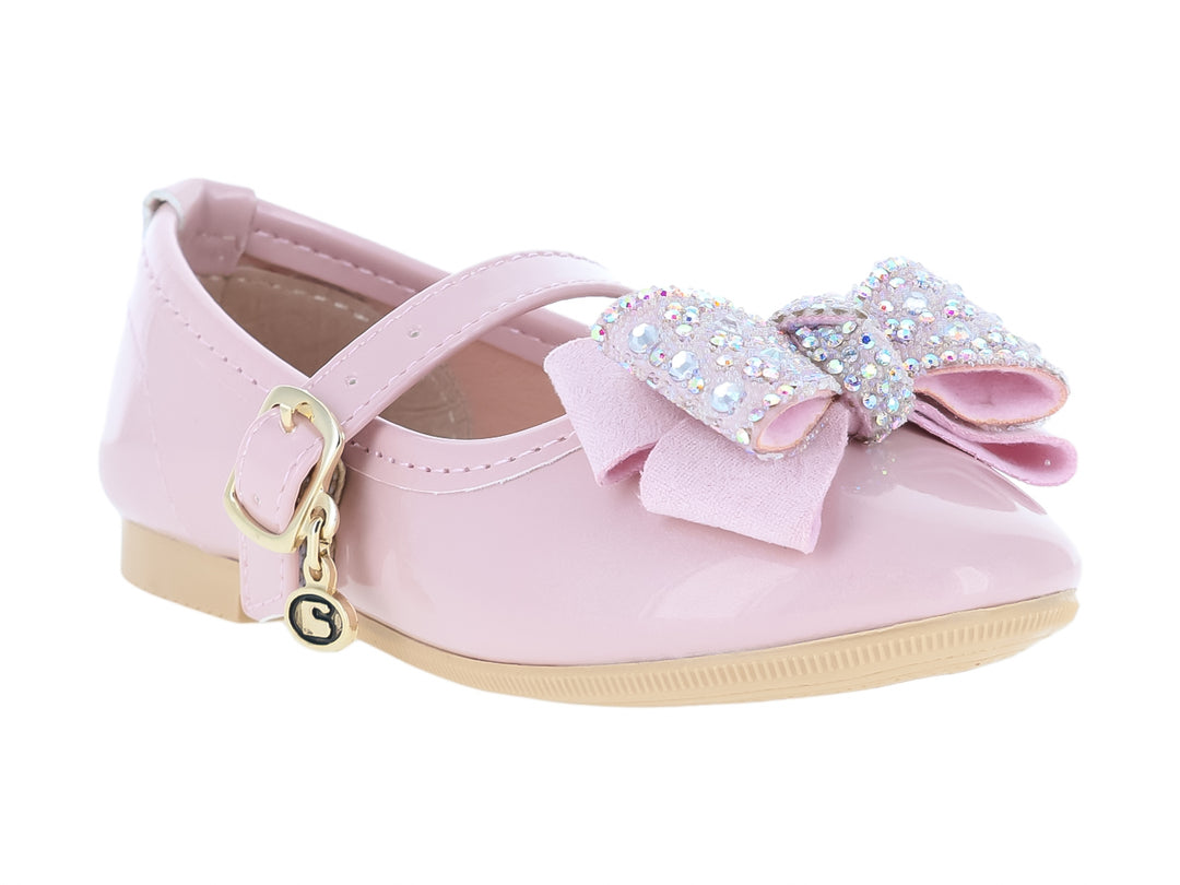 Zapato rosa tipo Mary Jane para niña con moño decorado con brillantes y correa con hebilla dorada.