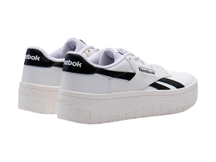 Tenis Reebok Court Advance Surge en color blanco con detalles negros y suela de plataforma alta.