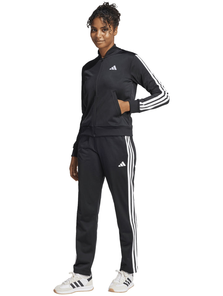 Conjunto deportivo Adidas negro con tres rayas blancas laterales en chaqueta y pantalón.