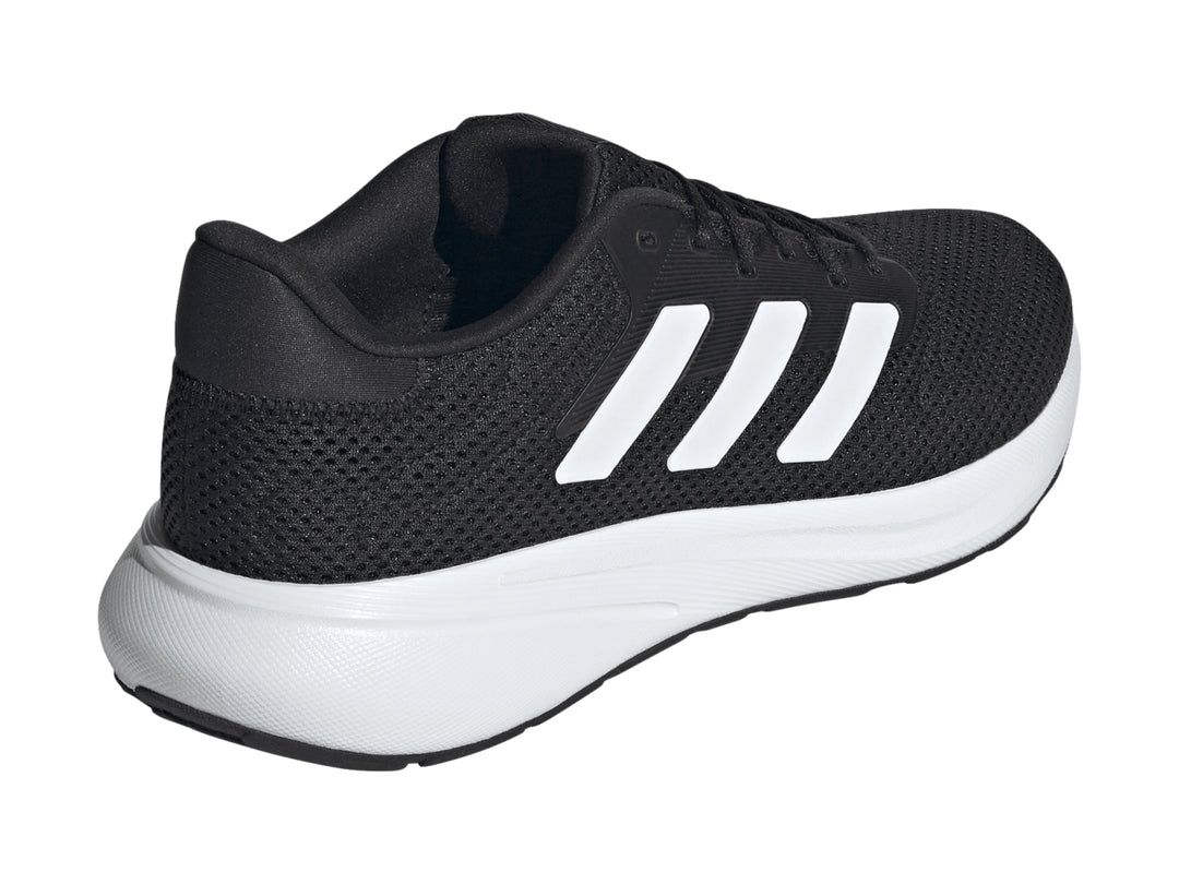 Tenis deportivos Adidas color negro con franjas y suela blanca.