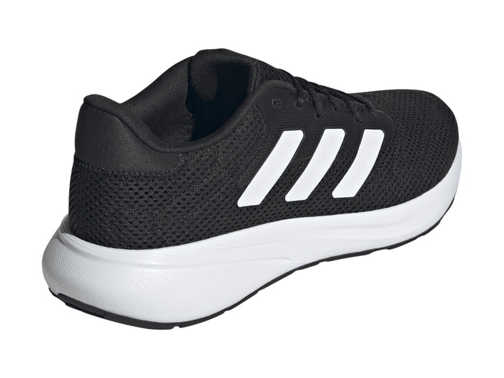 Tenis deportivos Adidas color negro con franjas y suela blanca.
