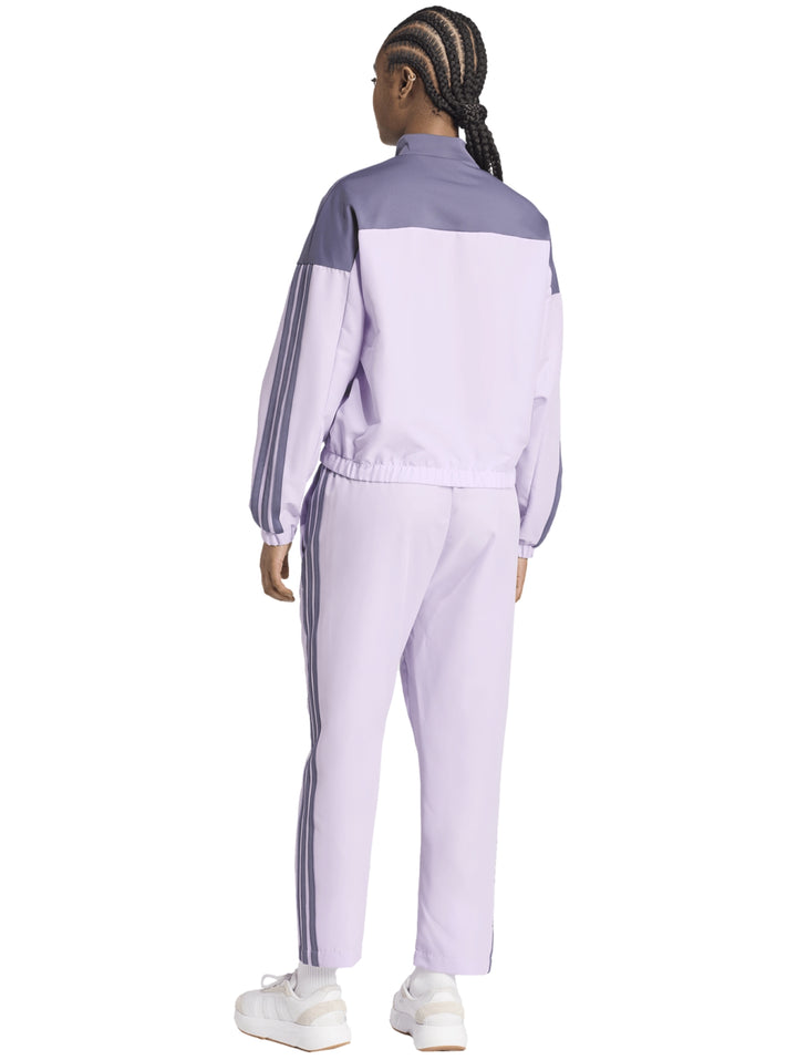 Conjunto deportivo Adidas Bold Block en color lila y gris, compuesto por chaqueta y pantalón para mujer.