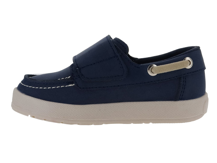 Zapato náutico infantil color azul marino con suela beige y pequeño detalle verde.