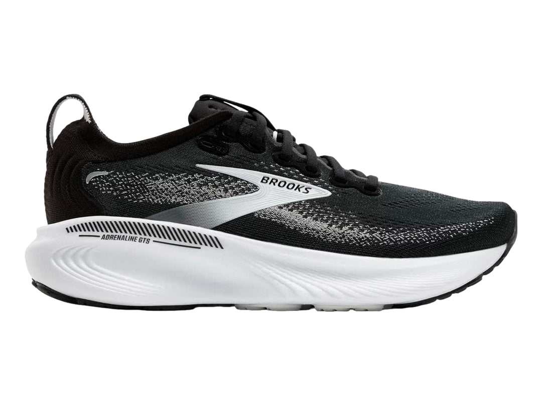 Tenis deportivos Brooks Adrenaline GTS en colores negro, gris y blanco con suela blanca gruesa.