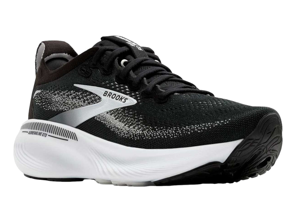 Tenis deportivos Brooks Adrenaline GTS en colores negro, gris y blanco con suela blanca gruesa.