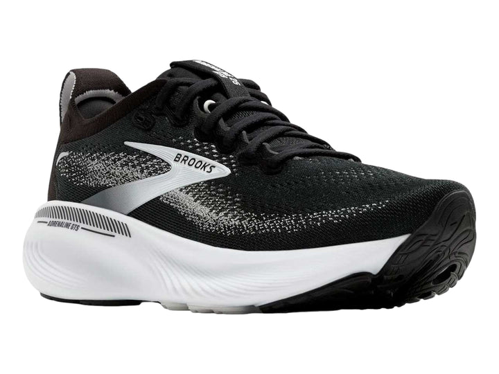 Tenis deportivos Brooks Adrenaline GTS en colores negro, gris y blanco con suela blanca gruesa.