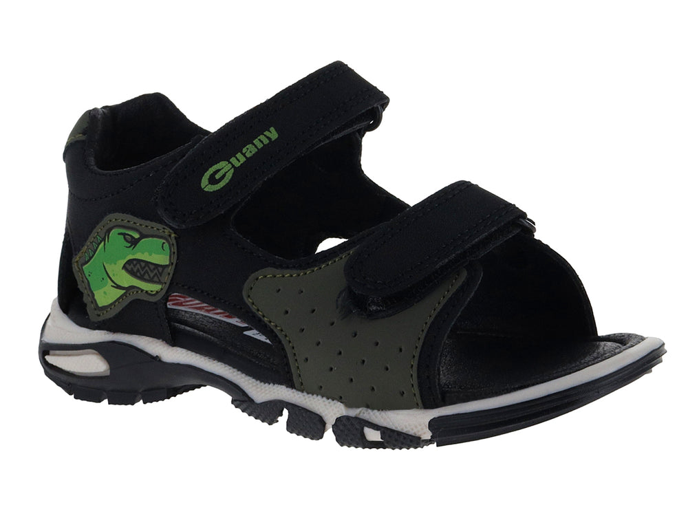 Sandalia infantil color negro con detalles verdes, dibujo de dinosaurio y suela blanca.