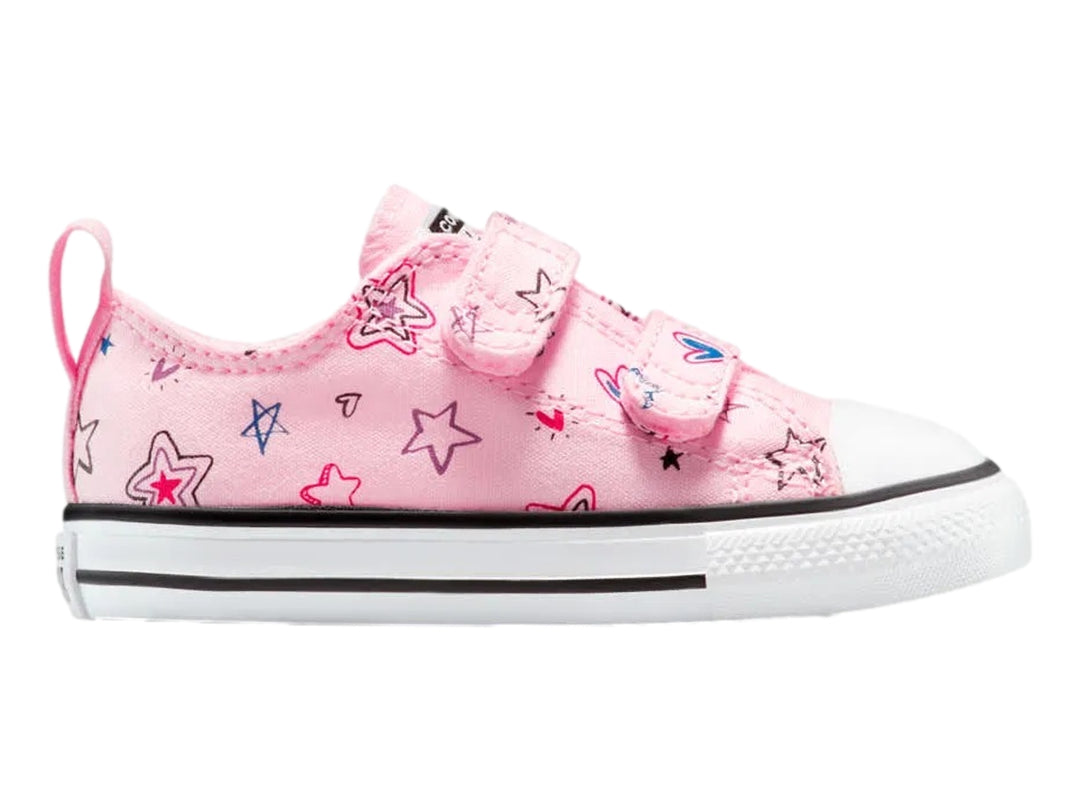 Tenis Converse rosa con estampado de estrellas y cierre de velcro.