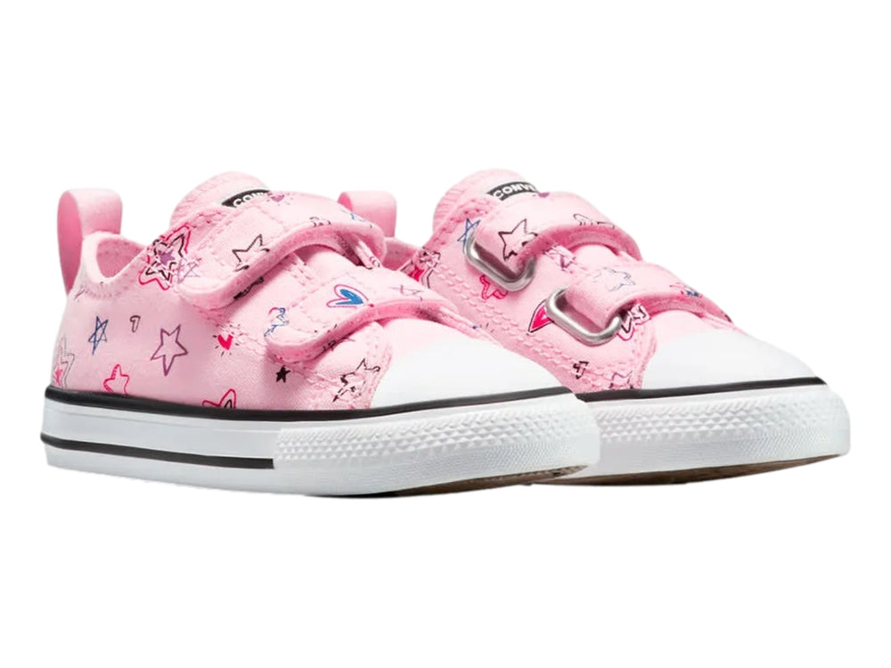 Tenis Converse rosa con estampado de estrellas y cierre de velcro.