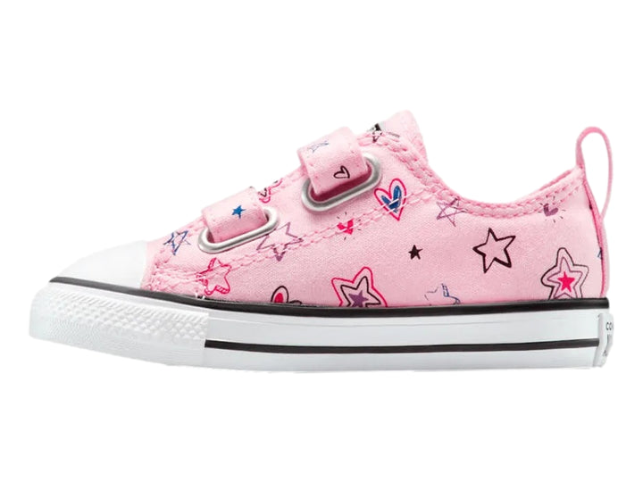 Tenis Converse rosa con estampado de estrellas y cierre de velcro.