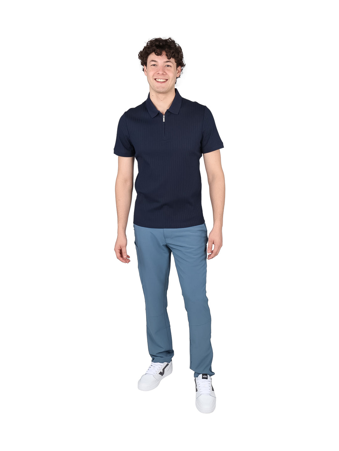 Hombre vistiendo una playera polo azul marino con cuello de cierre y textura acanalada.