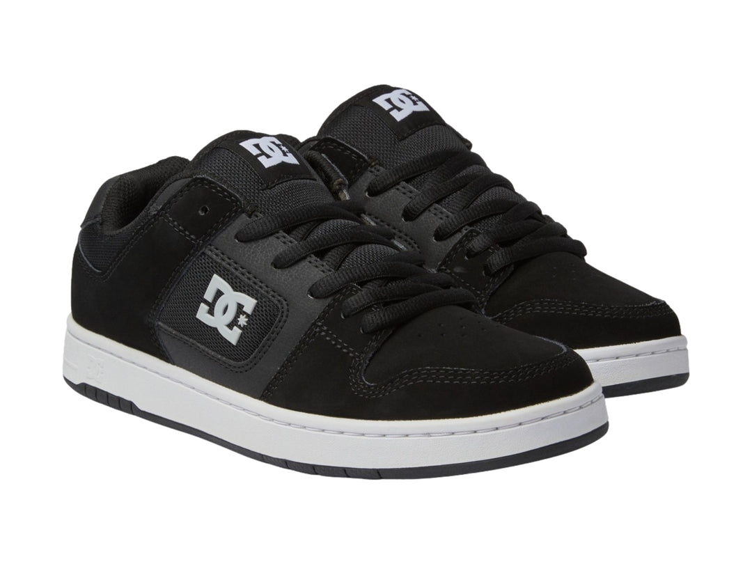 Tenis DC Shoes Manteca 4 color negro con suela blanca y logotipo DC blanco en el lateral.