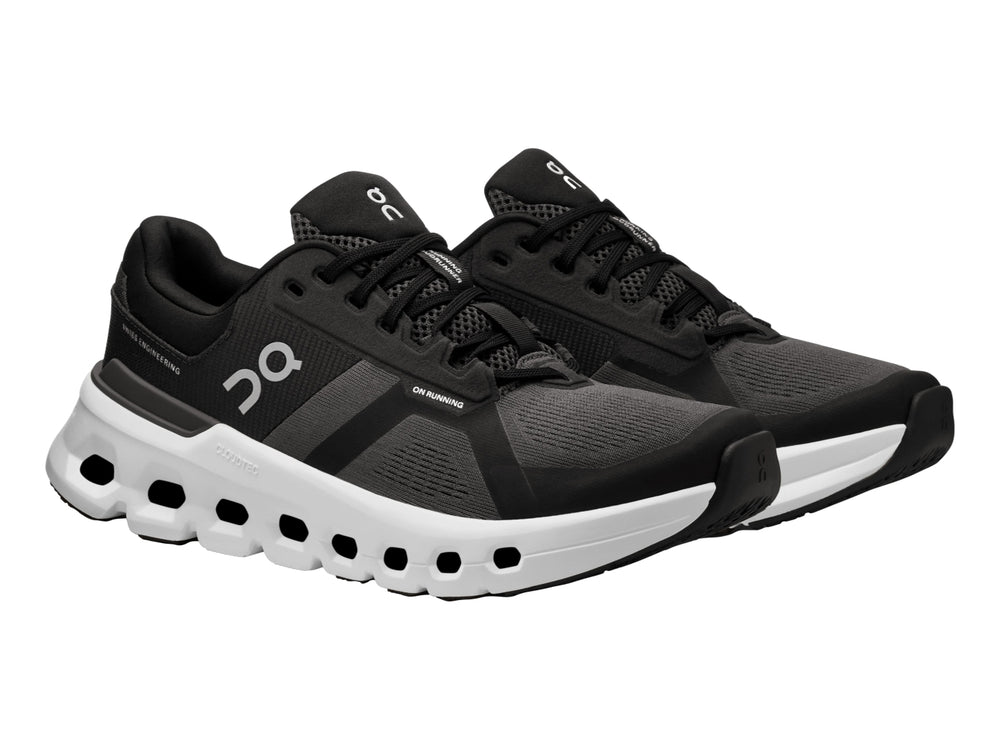 Tenis deportivos ON Cloudrunner 2 en color negro con suela blanca característica de diseño perforado.