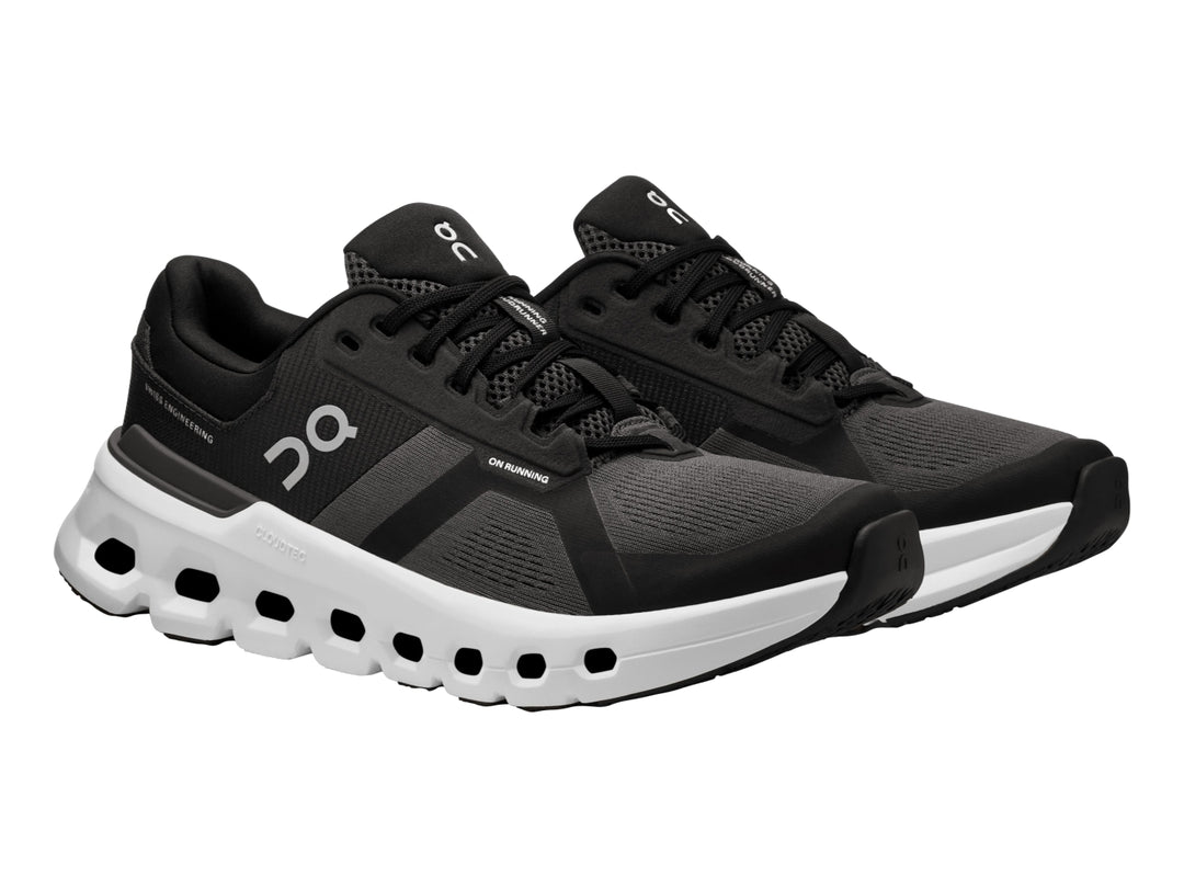 Tenis deportivos ON Cloudrunner 2 en color negro con suela blanca característica de diseño perforado.