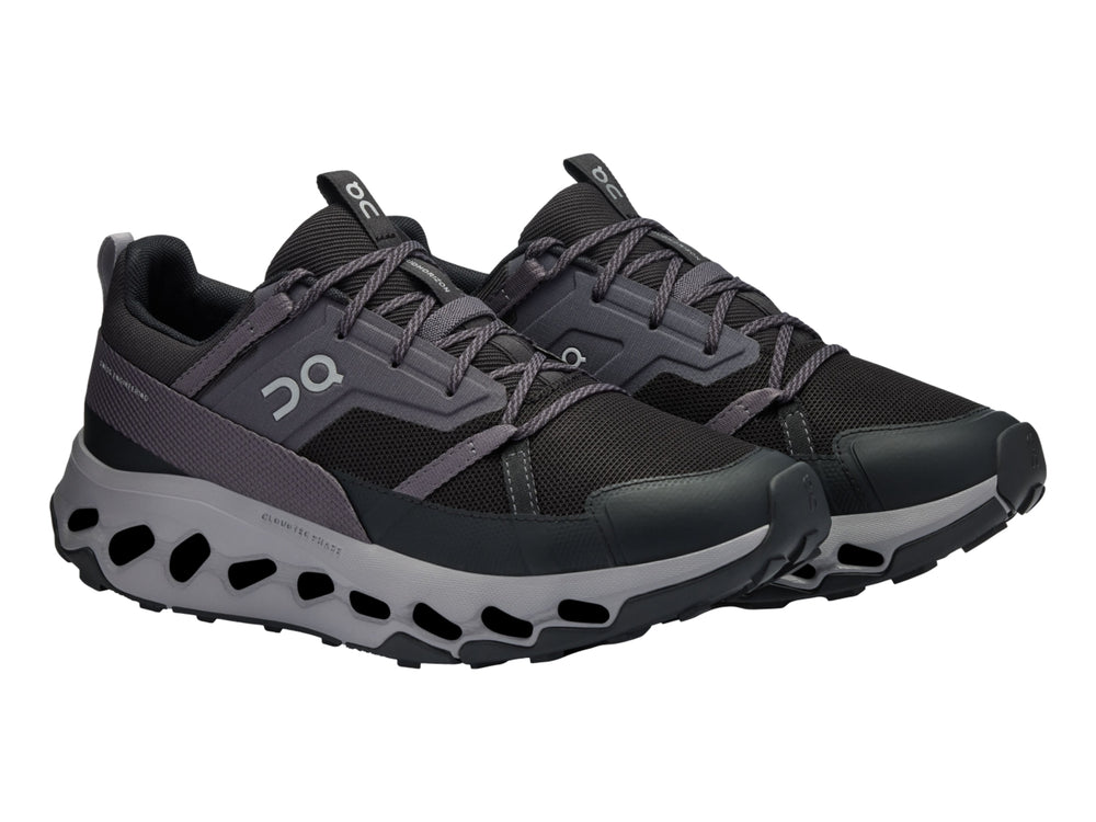 Tenis deportivos On Cloud en color negro y gris con suela amortiguada característica.