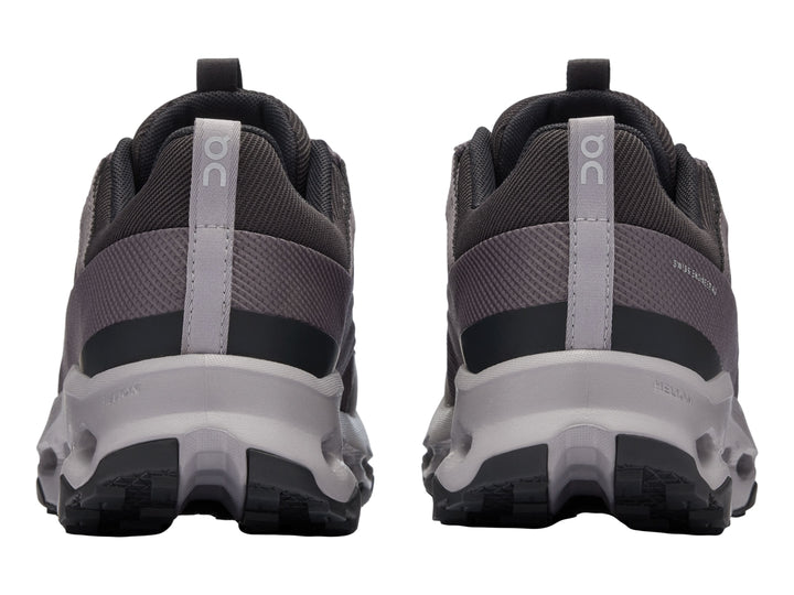 Tenis deportivos On Cloud en color negro y gris con suela amortiguada característica.