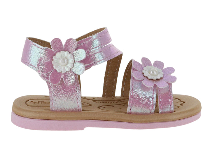 Sandalias rosas metálicas para niña con adornos de flores blancas y suela marrón.