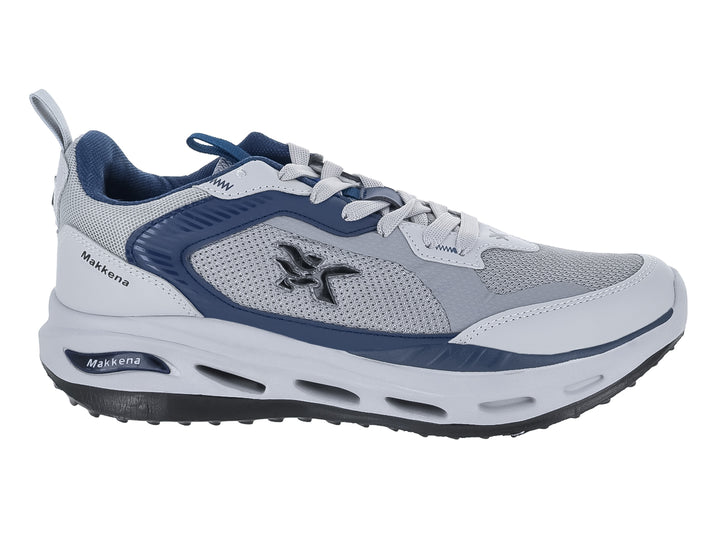 Tenis deportivos Makkena en colores gris, blanco y azul marino con suela blanca y detalles en malla.