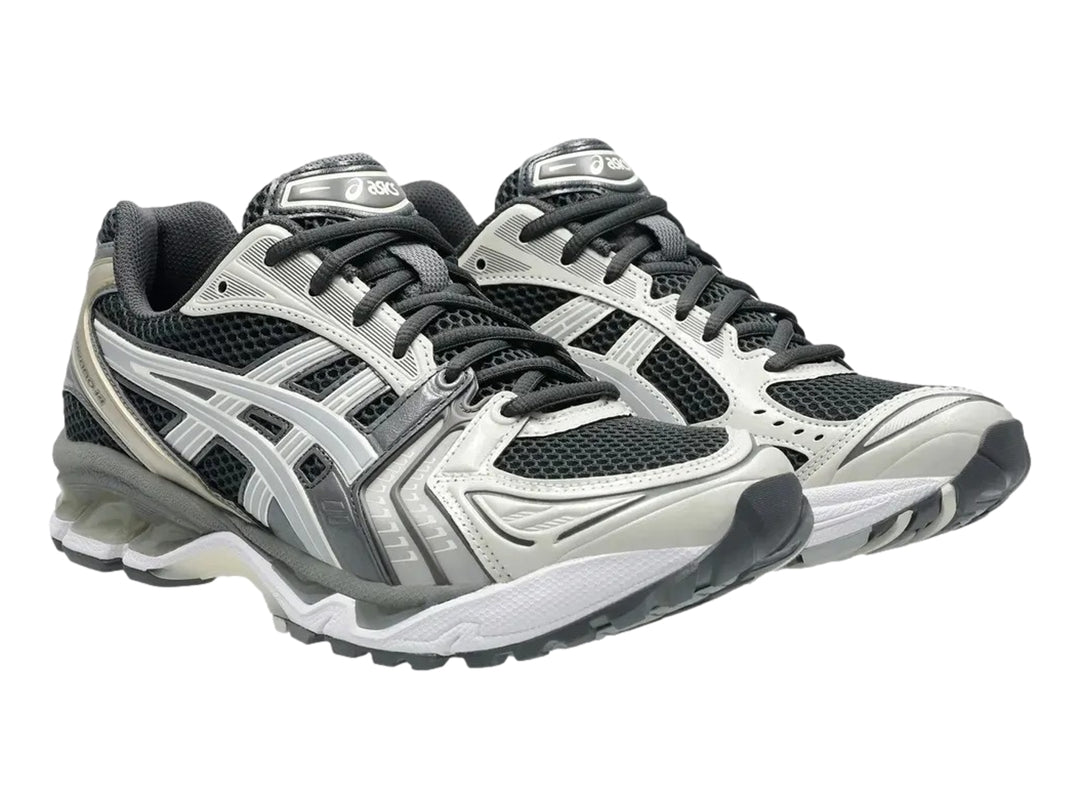 Tenis deportivos ASICS Gel-Kayano 14 en colores gris, blanco y negro con suela amortiguada.